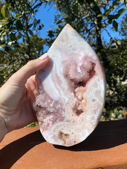 Rose Amethyst Tear Drop glows under the sun, revealing large lavender amethyst crystals within its stunning geode cavity