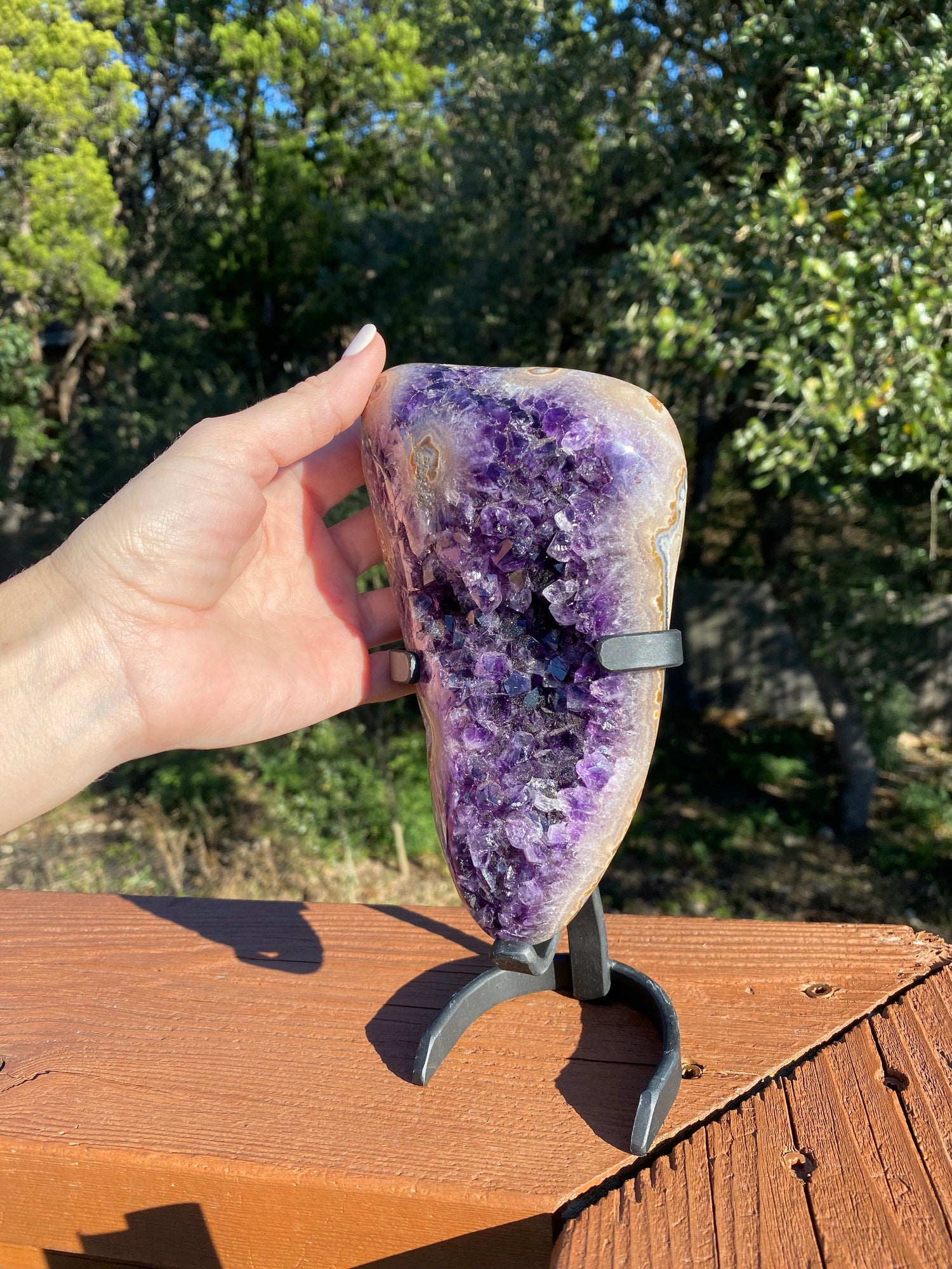 agate and amethyst freeform, sparkling under sunlight, revealing vibrant purple crystals and the detailed banding of polished agate