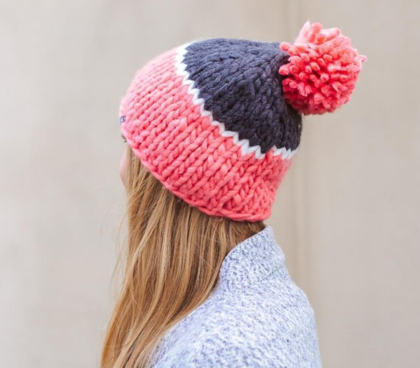 Color-blocked Carly Cozy Beanie, offering warmth and style with a slouchy fit and a faux fur pom-pom, one size fits all