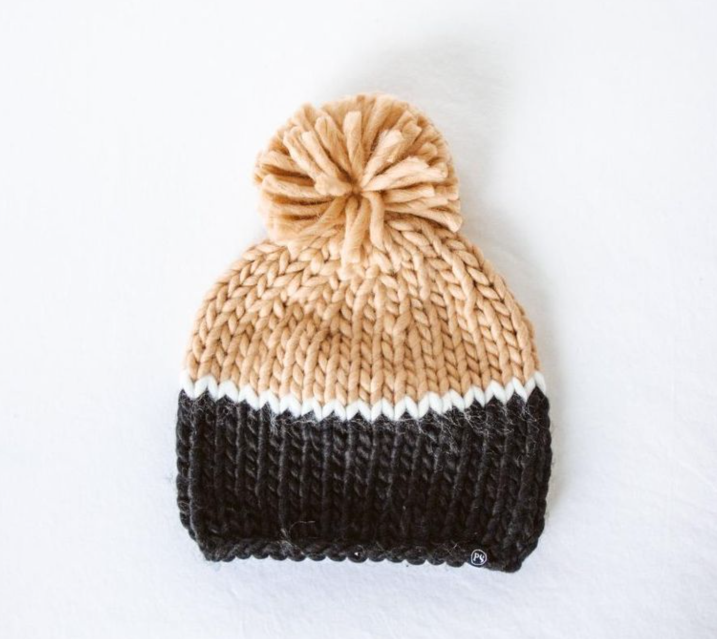 Cozy color-blocked beanie with a slouchy fit, made from 100% acrylic with a faux fur pom-pom for a cute, winter-ready style