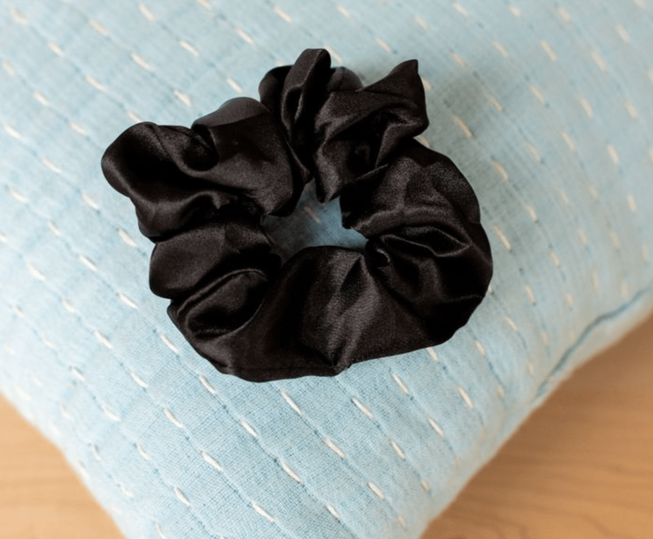 Set of black satin scrunchies, perfect for dressing up casual or formal looks with a smooth, sleek finish.