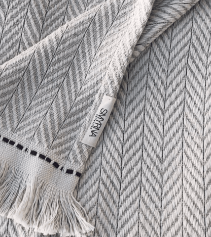 Hand-loomed 100% Turkish cotton Jacqueline Chevron Throw, perfect for adding warmth and style with its chevron pattern and fringe