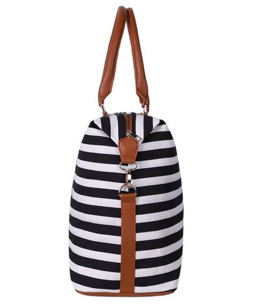 Stylish Aztec Weekender Bag featuring gold hardware, spacious pockets, and durable cognac straps, ideal for travel.