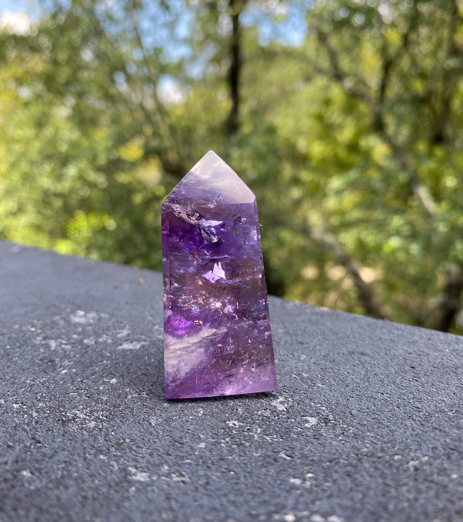 Amethyst translucent crystal tower, a semi-precious gemstone known for wisdom and spiritual healing.