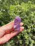 Polished Brazilian Amethyst crystal tower with translucent lavender and purple hues, promoting calmness and spiritual healing.