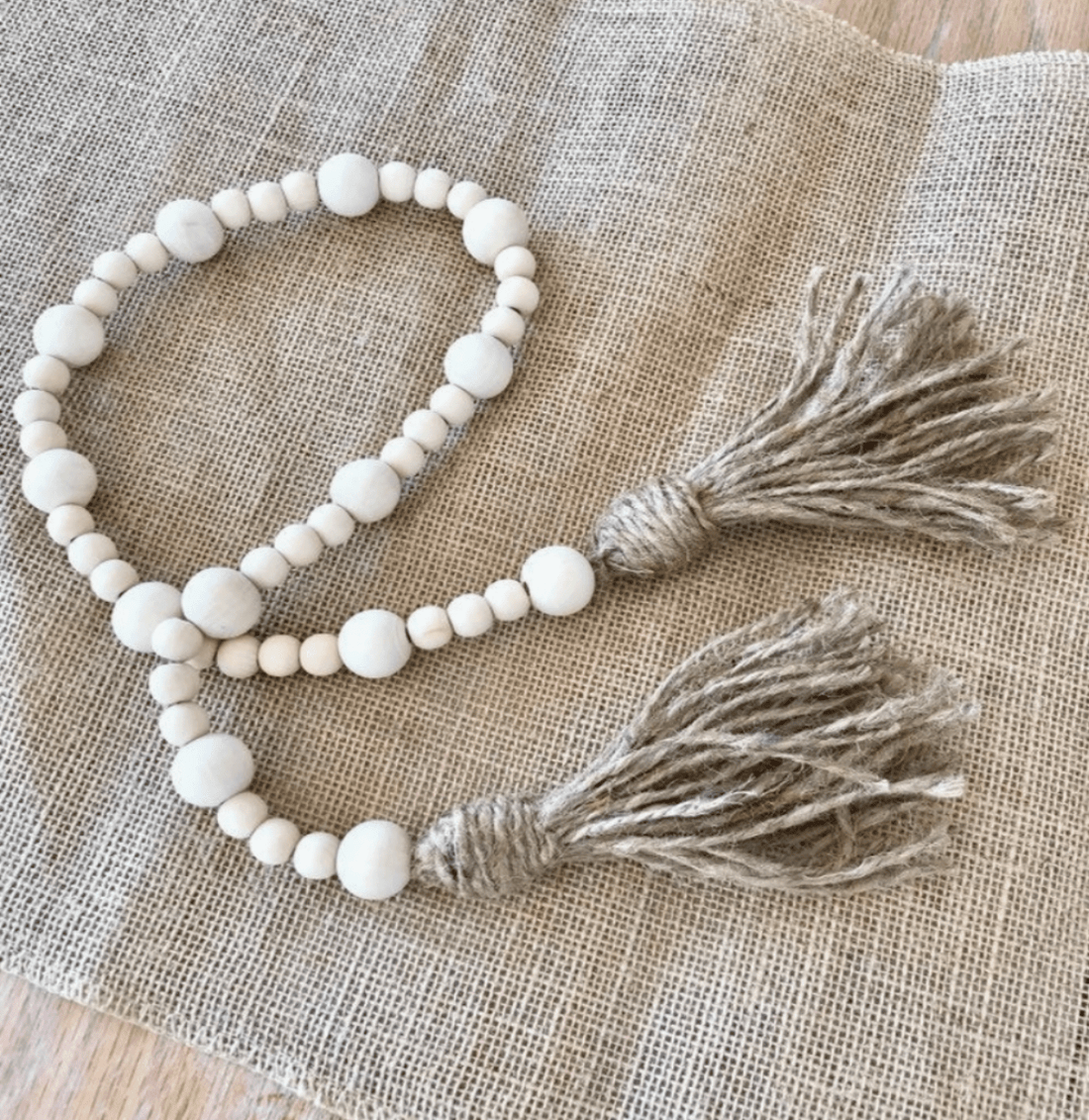 Cream-colored Zoe Beaded Garland – a beautiful accent piece with hand-painted wood beads, ideal for gifting or home decoration