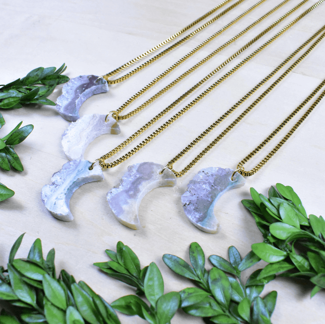 Amethyst slice crescent moon necklace with a gold-plated stainless steel box chain, perfect for self-care or gifting.