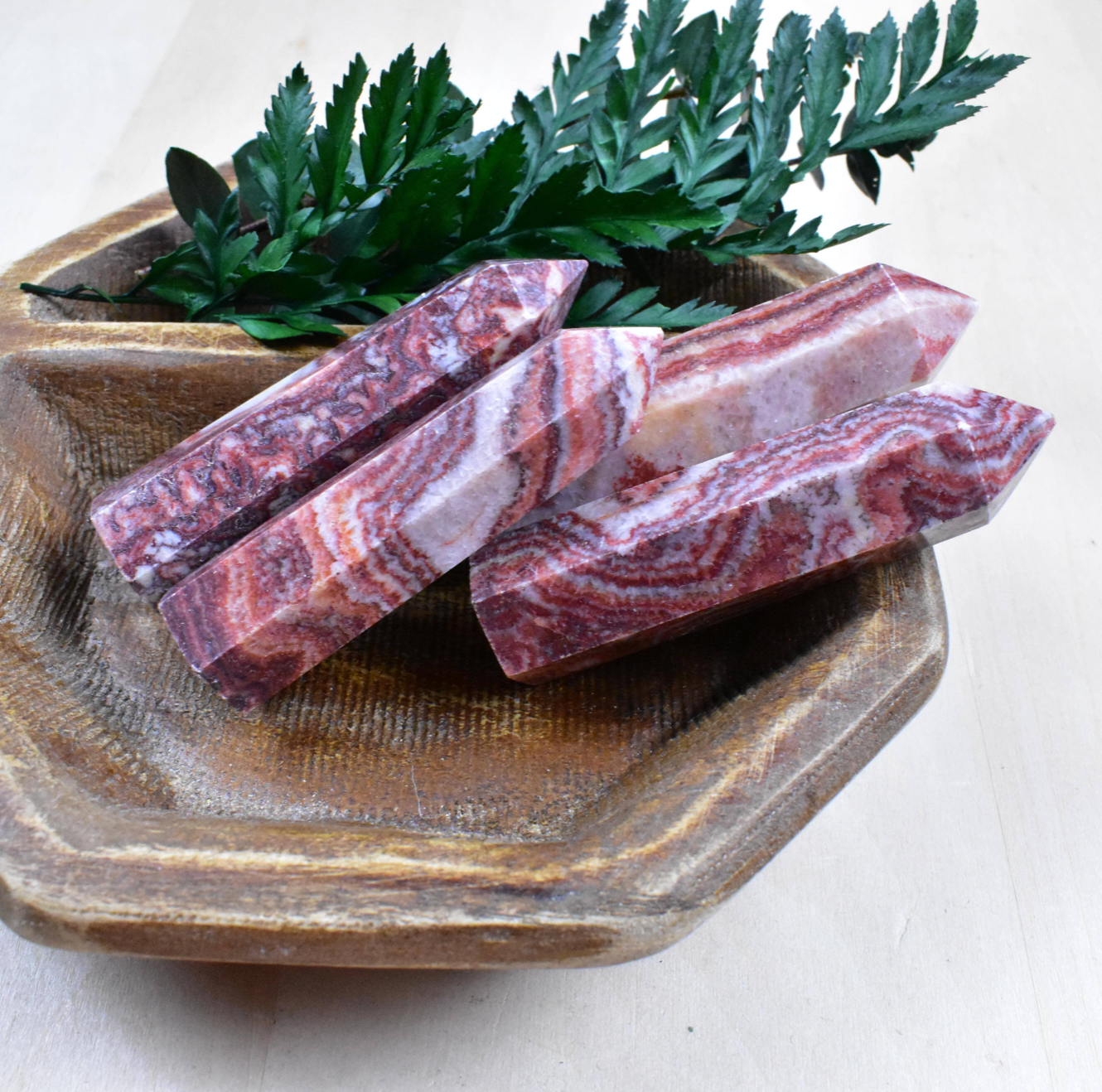 Stunning Rhodochrosite Points in a group, featuring vibrant pink tones that open the heart and encourage a positive outlook on life