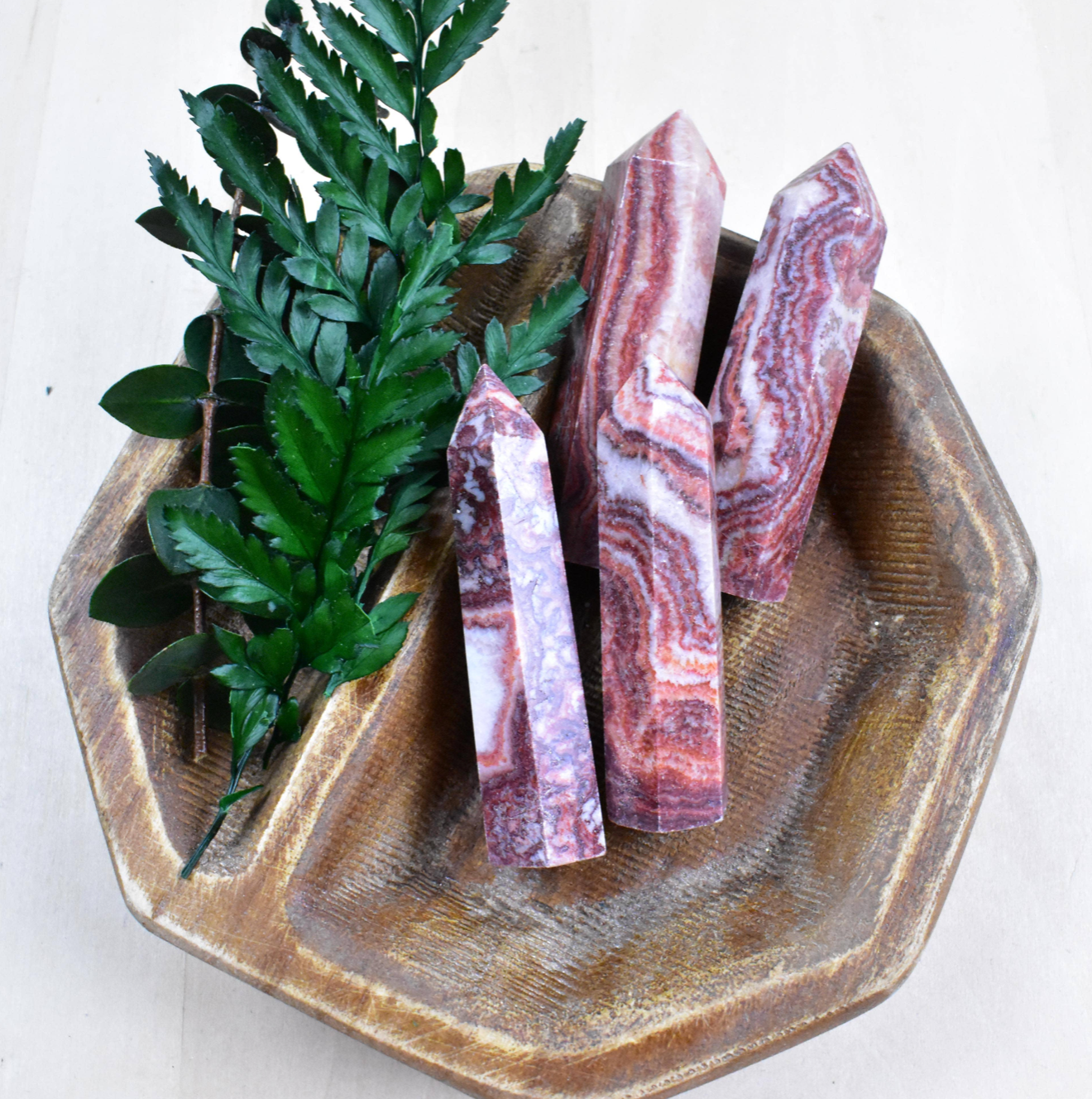 Group of Rhodochrosite Points showcases vibrant pink shades, known for balancing energy, promoting healing, and lifting the spirit