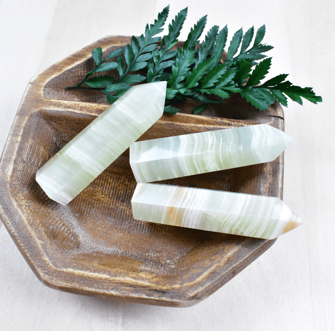 Green Afghan Jade Point: A powerful heart chakra stone, shielding from negativity and enhancing positive energy with swirling greens.