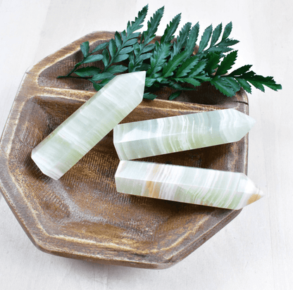 Green Afghan Jade Point: A powerful heart chakra stone, shielding from negativity and enhancing positive energy with swirling greens.