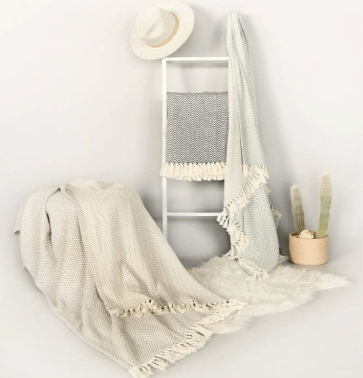 Jacqueline Chevron Throw, 100% Turkish cotton, hand-loomed with a chevron pattern, adding warmth and style to any space