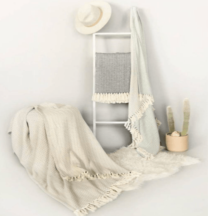 Jacqueline Chevron Throw, 100% Turkish cotton, hand-loomed with a chevron pattern, adding warmth and style to any space