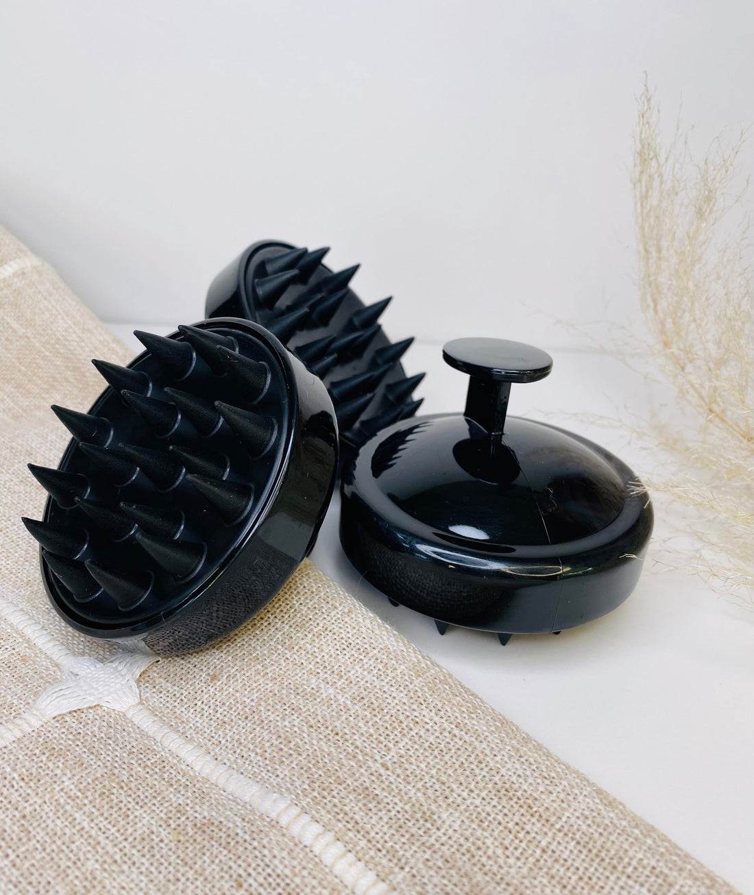 Shower massager brush for hair and scalp, offering gentle exfoliation and deep cleaning with soft scrubbers.