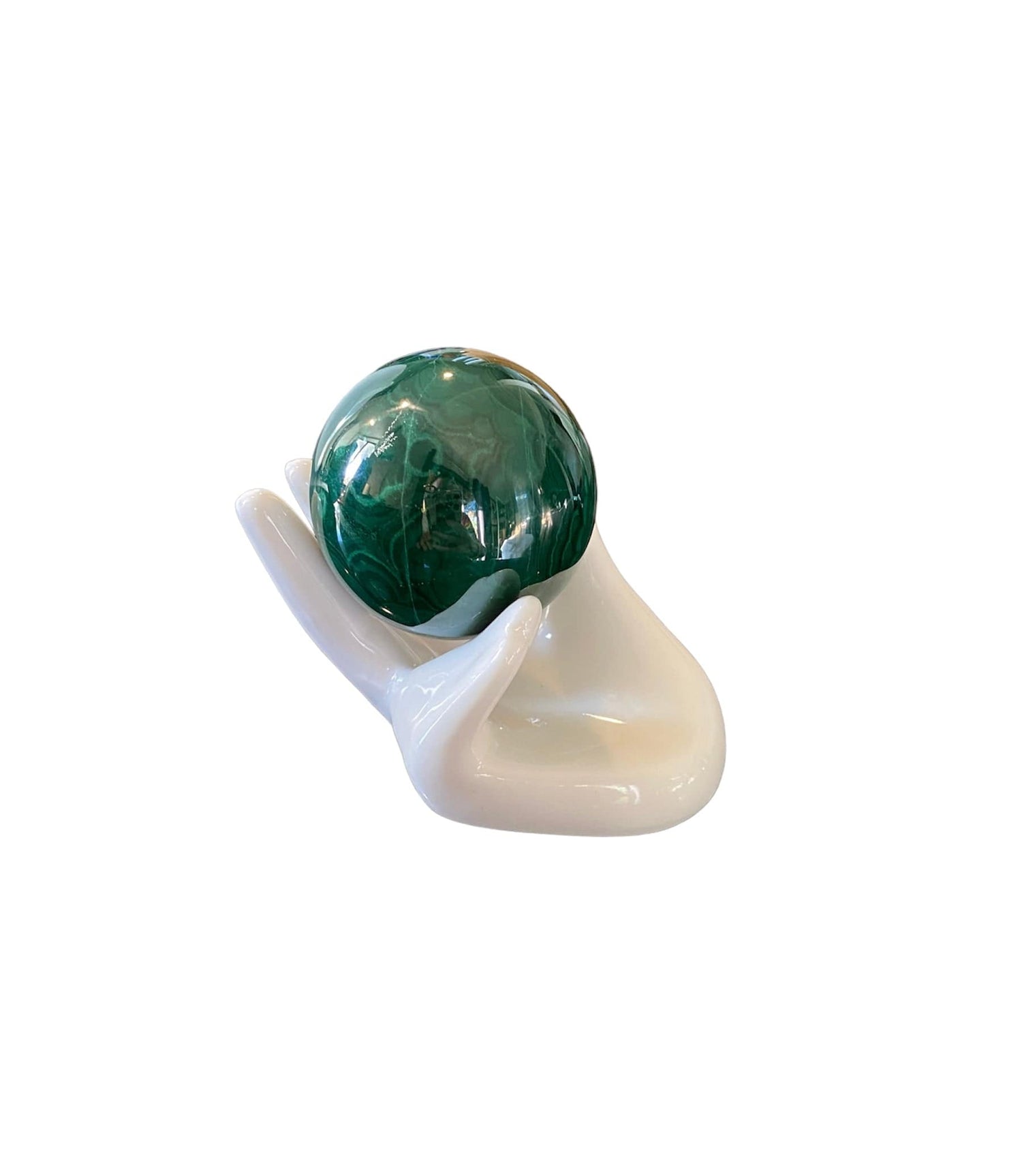 Mini ceramic hand display holding a crystal, showcasing how it elegantly displays delicate treasures