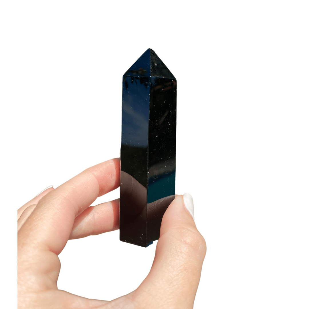 Obsidian Tower, a smooth and polished volcanic stone, known for absorbing negative energy and revealing the truth, linked to the root chakra