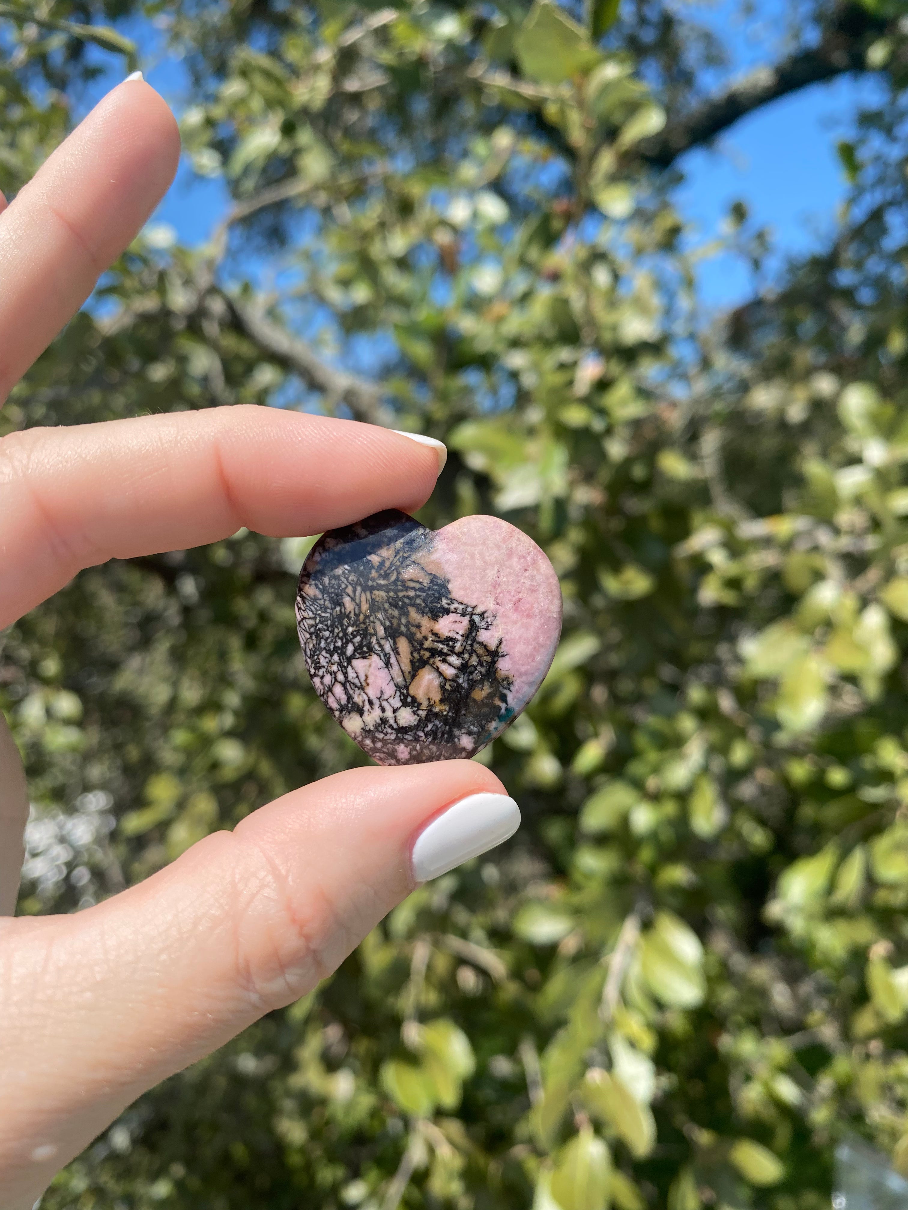 Rhodonite heart stone, promotes compassion and emotional healing, perfect for clearing emotional wounds and balancing energy