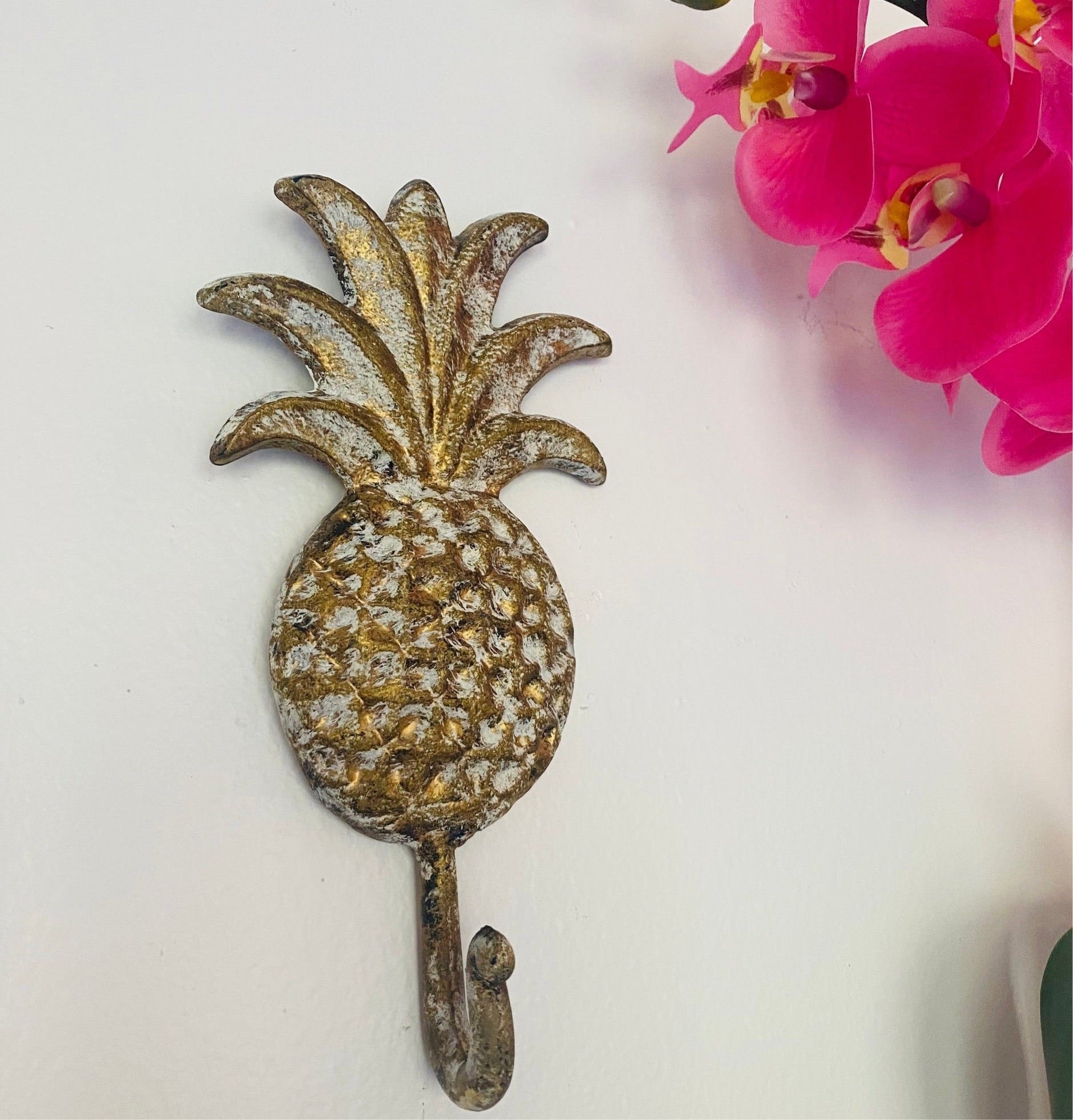 stylish gold-finish Pineapple Wall Hook brings a fun, tropical vibe to your home while being perfect for hanging essentials and gifting