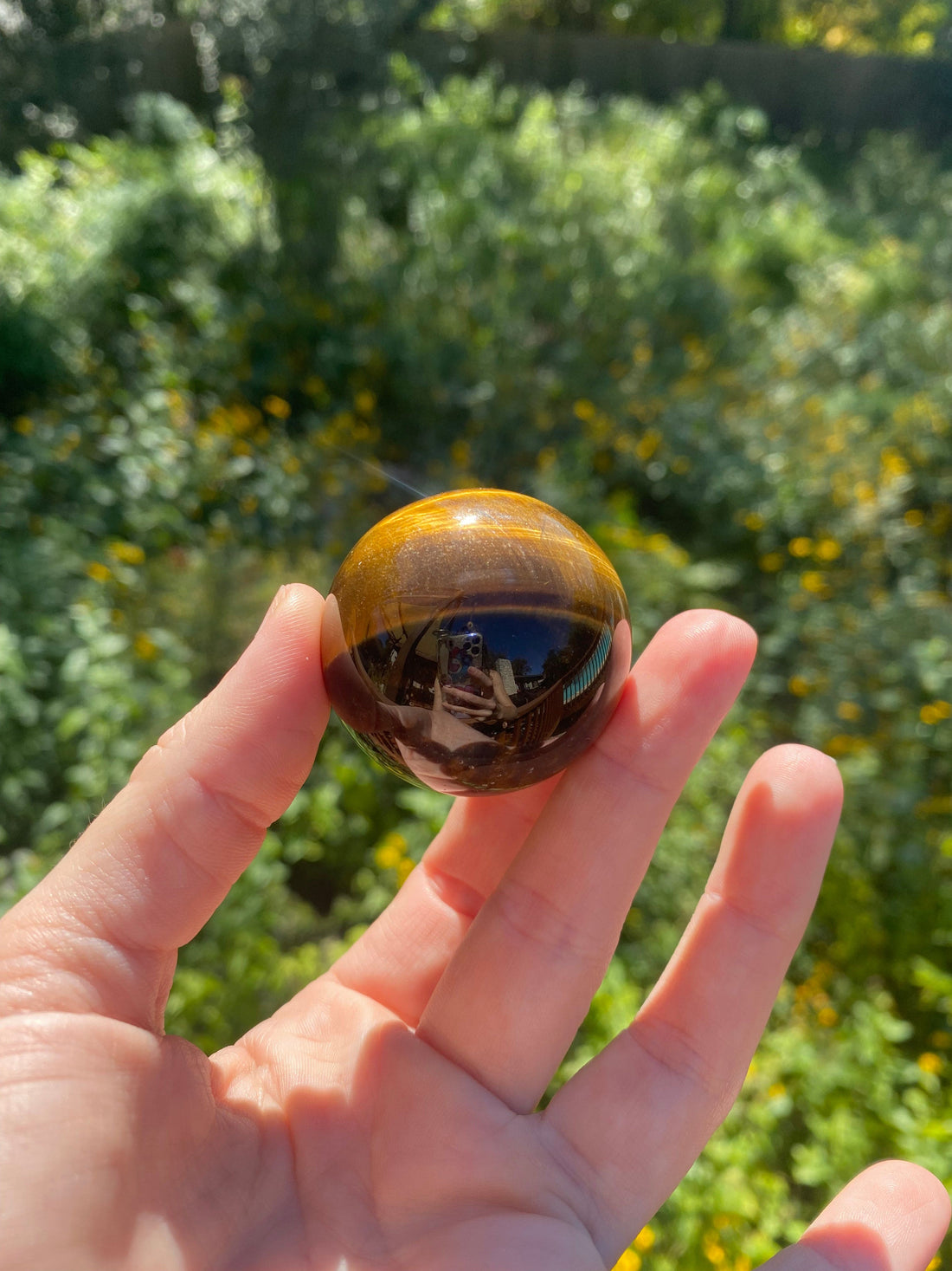 Held in the sunlight, the Tiger’s Eye Sphere reveals stunning golden-brown hues, radiating grounding and protective energy