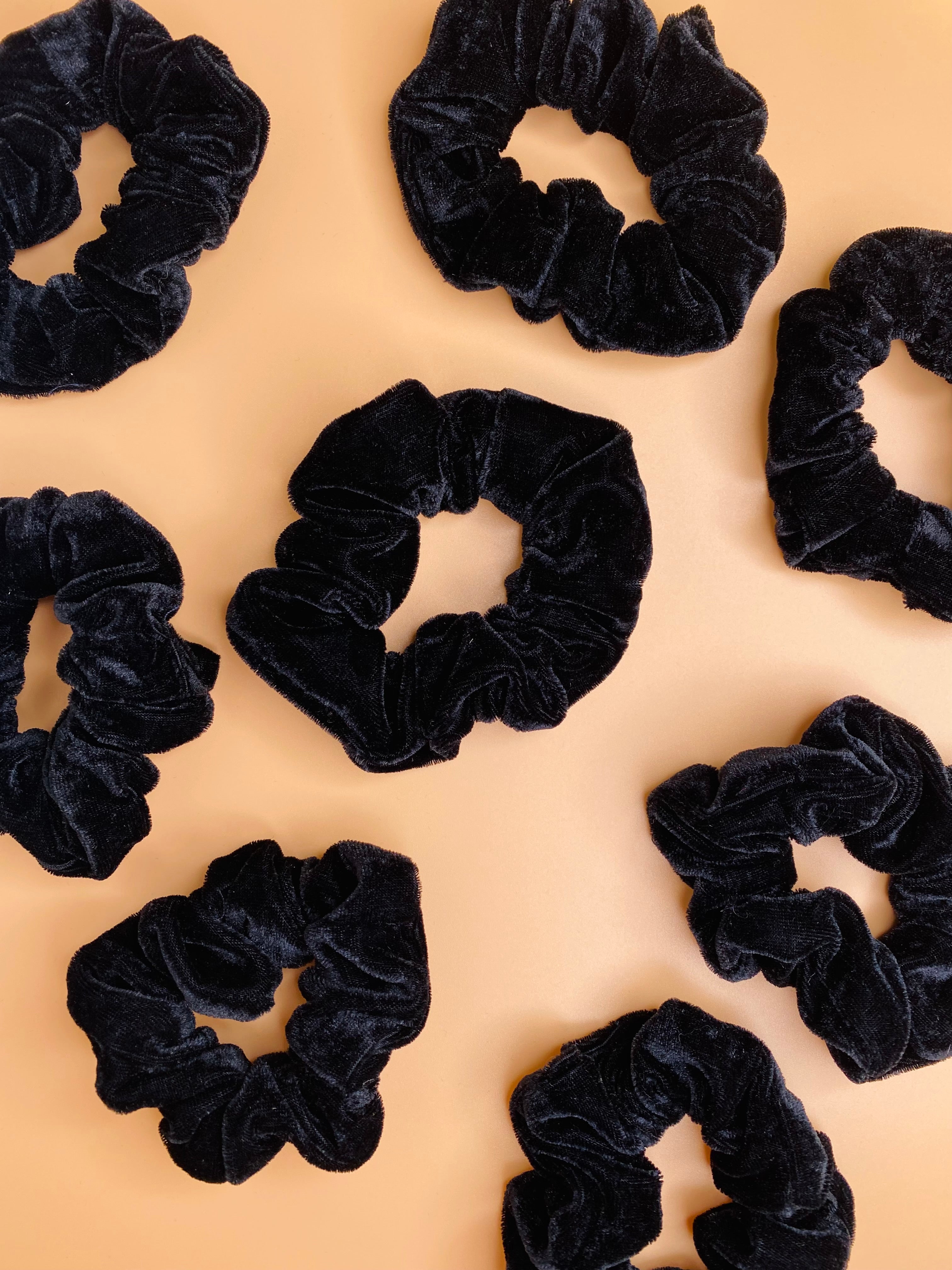 Rochelle Black Velvet Scrunchie adds a touch of style to any look, with soft velvet material and a secure hold for your messy bun