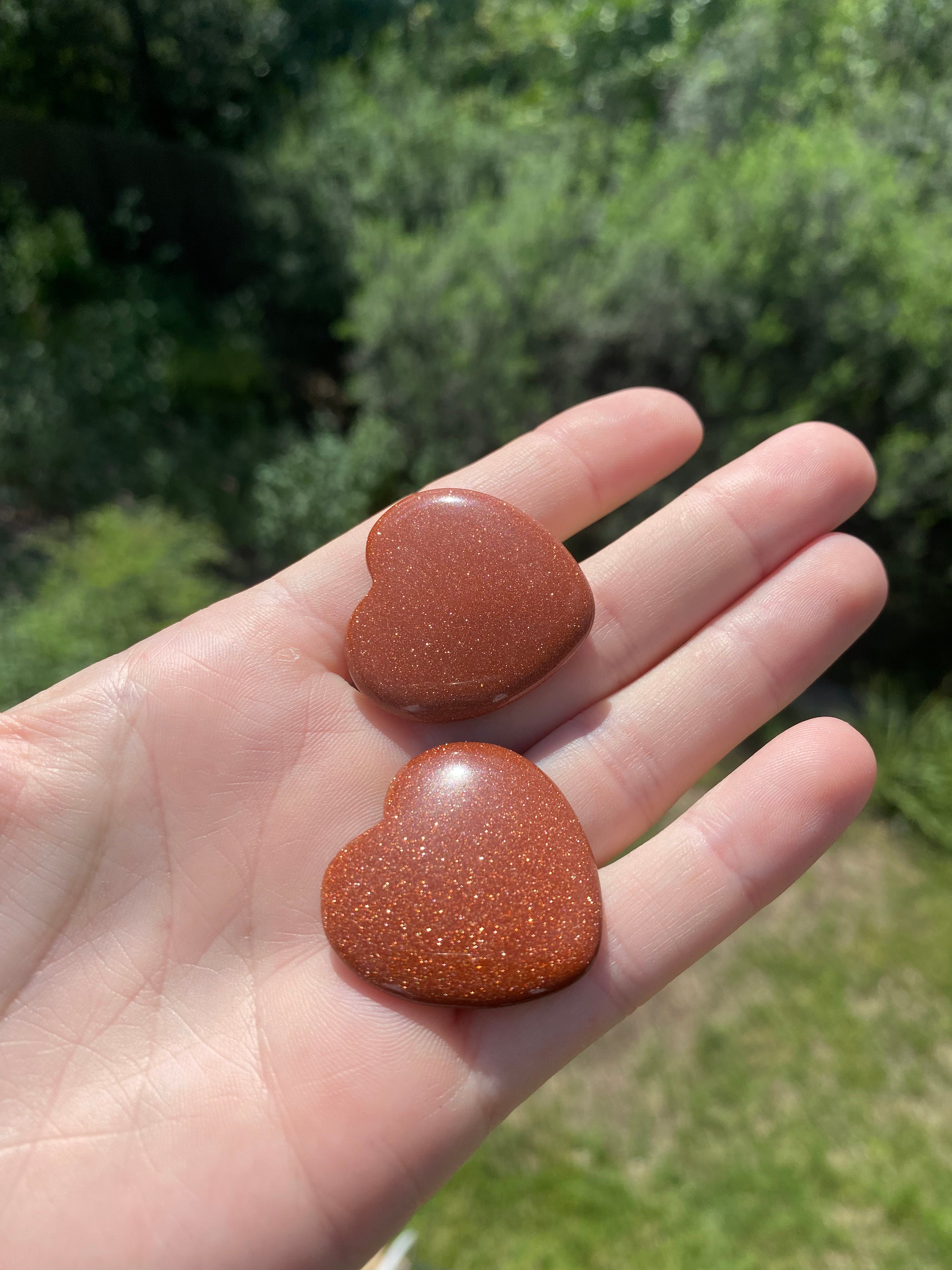 Goldstone heart, ideal for boosting personal power and ambition, encourages optimism while stabilizing emotions and calming the mind