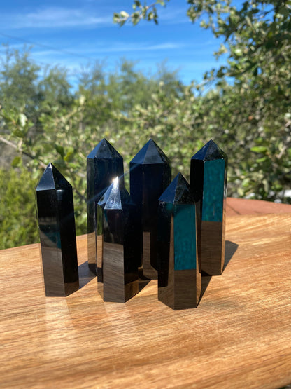 This smooth Obsidian Tower is highly protective, connected to the root chakra, and known for absorbing negativity and promoting self-awareness