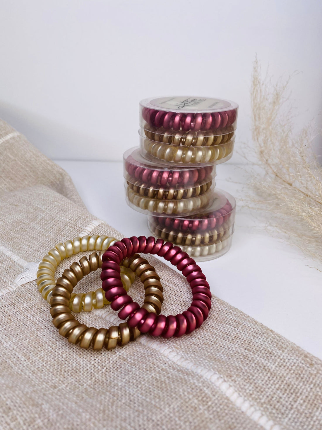 Set of 3 Rosé Coil Hair Ties, designed to be ouch-less and crease-less, offering a gentle hold in gorgeous colors