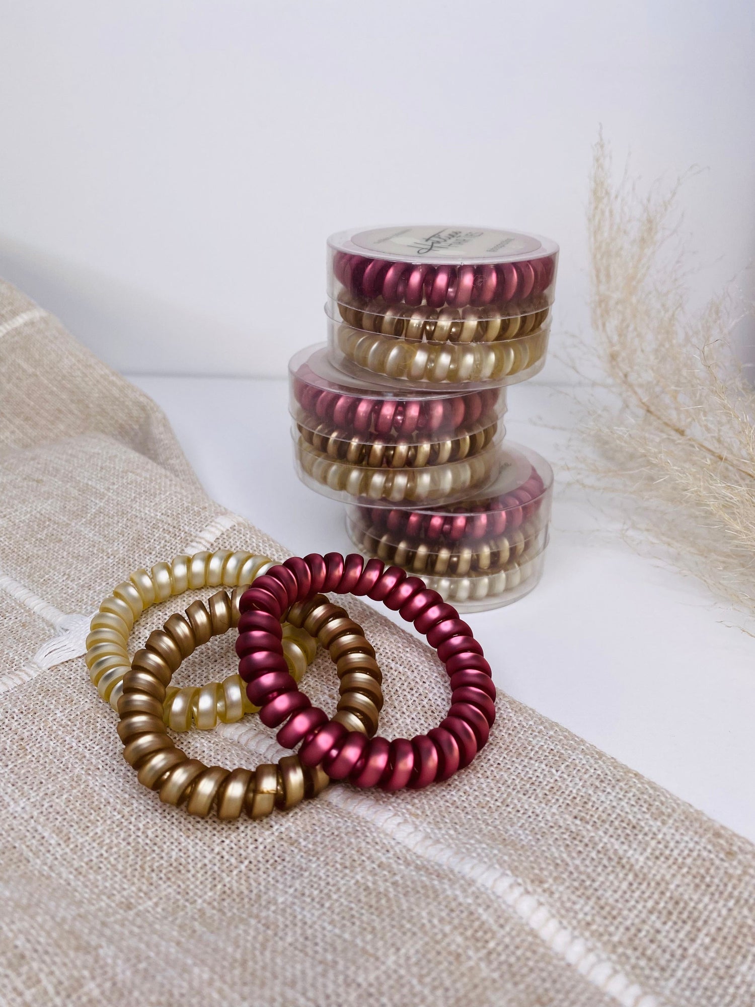 Set of 3 Rosé Coil Hair Ties, designed to be ouch-less and crease-less, offering a gentle hold in gorgeous colors