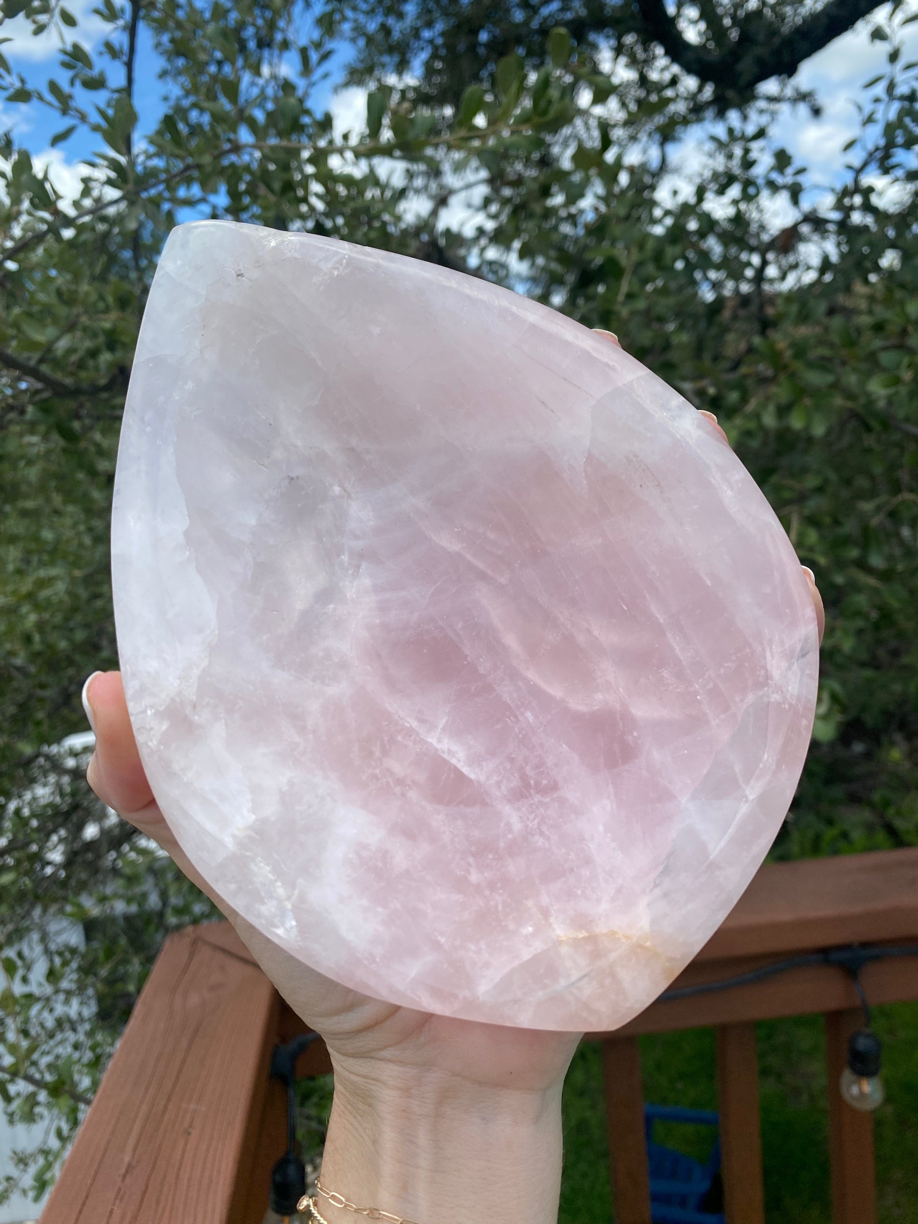 Held under sunlight, the Rose Quartz Bowl radiates a soft, glowing pink, representing harmony, love, and heart chakra energy