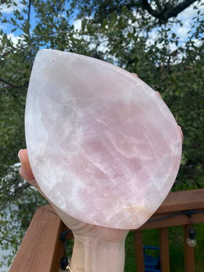 Held under sunlight, the Rose Quartz Bowl radiates a soft, glowing pink, representing harmony, love, and heart chakra energy