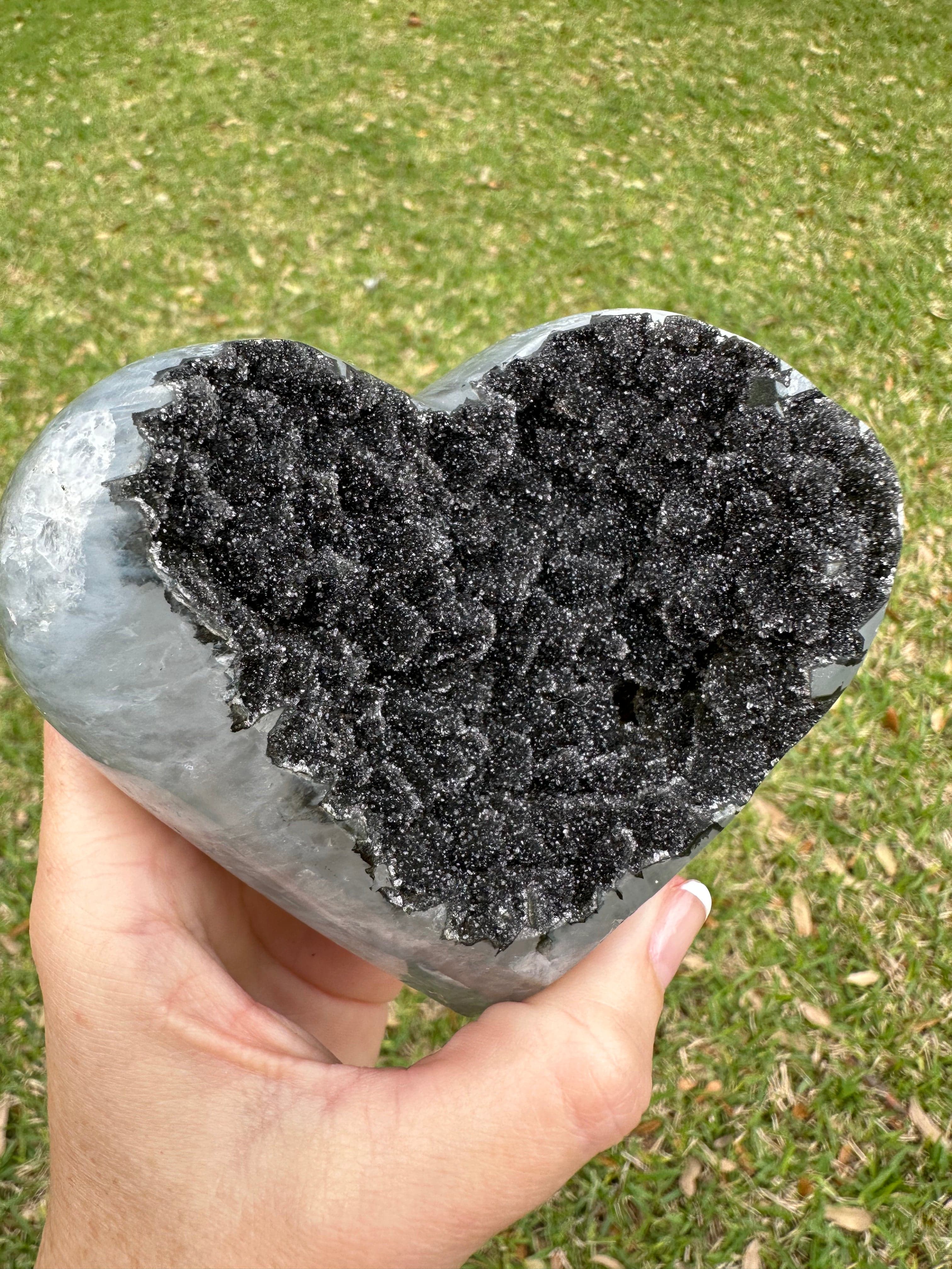 Up close, this rare Black Amethyst Heart showcases mesmerizing dark crystals that emanate calm and balance