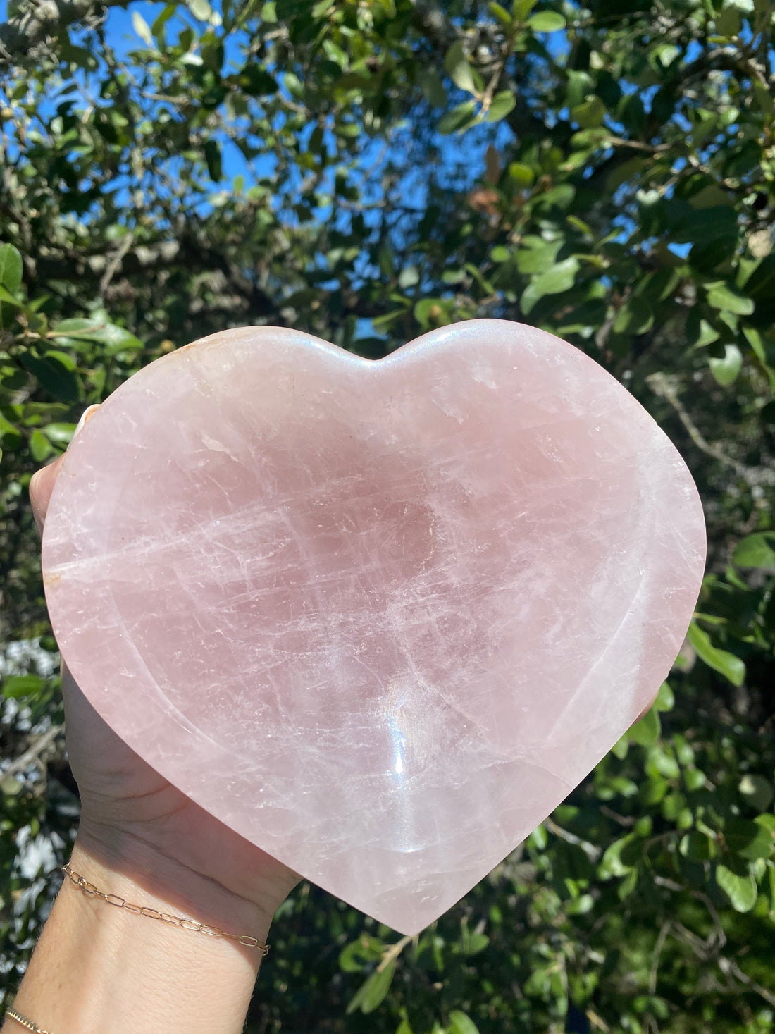 Rose Quartz Polished Heart Bowl glows under the sun, revealing its soft pink hues, symbolizing universal love and compassion