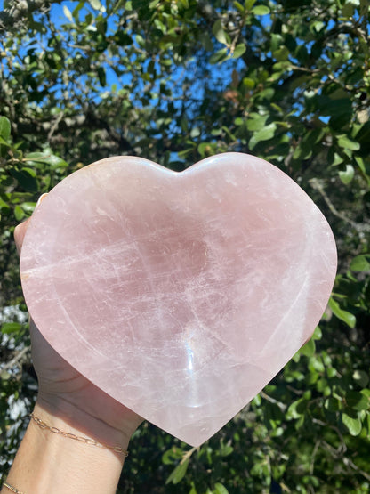 Rose Quartz Polished Heart Bowl glows under the sun, revealing its soft pink hues, symbolizing universal love and compassion