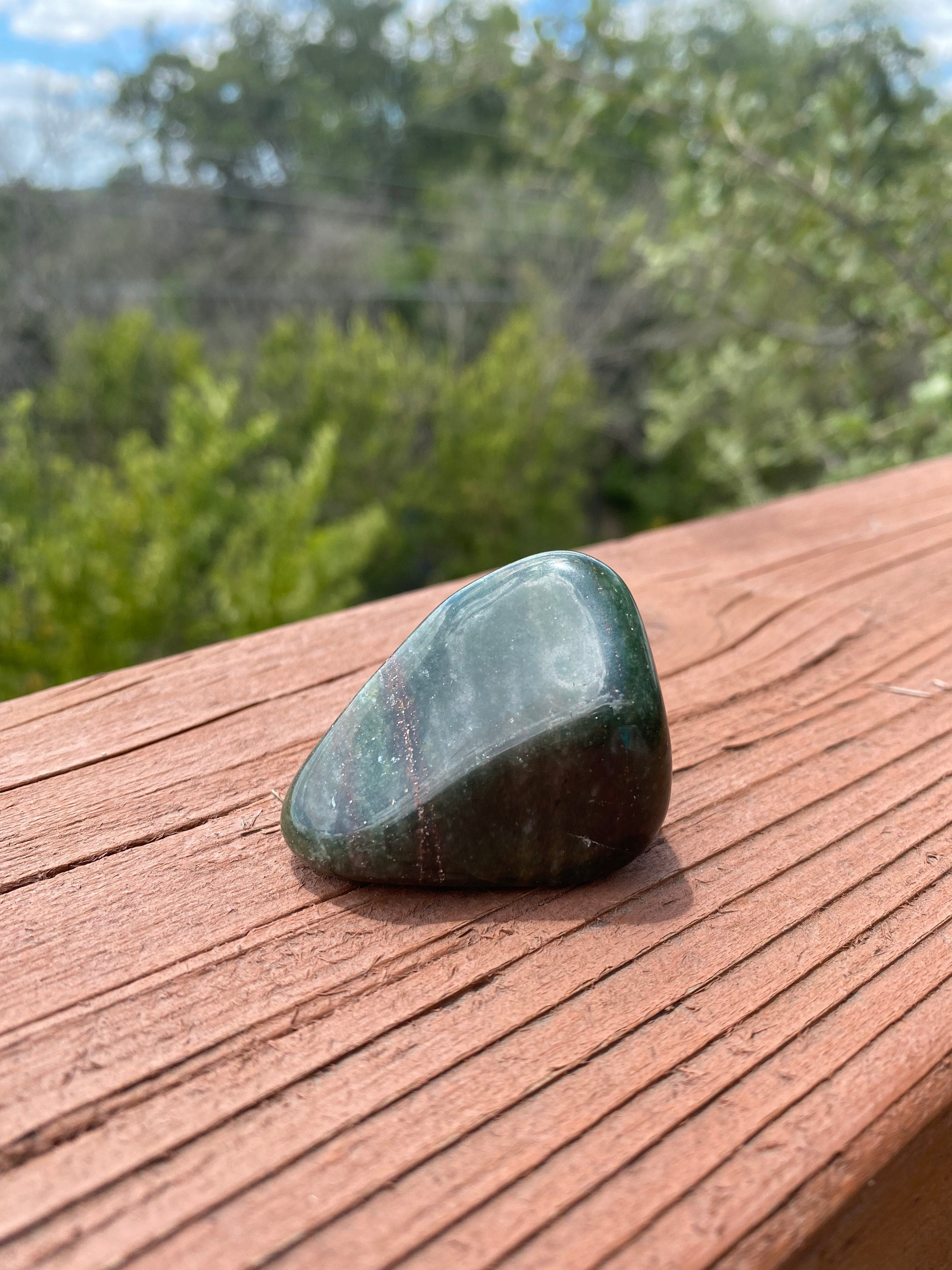 Under the sunlight, Green Jasper tumble glows with a serene energy, enhancing its ability to bring calm and emotional balance