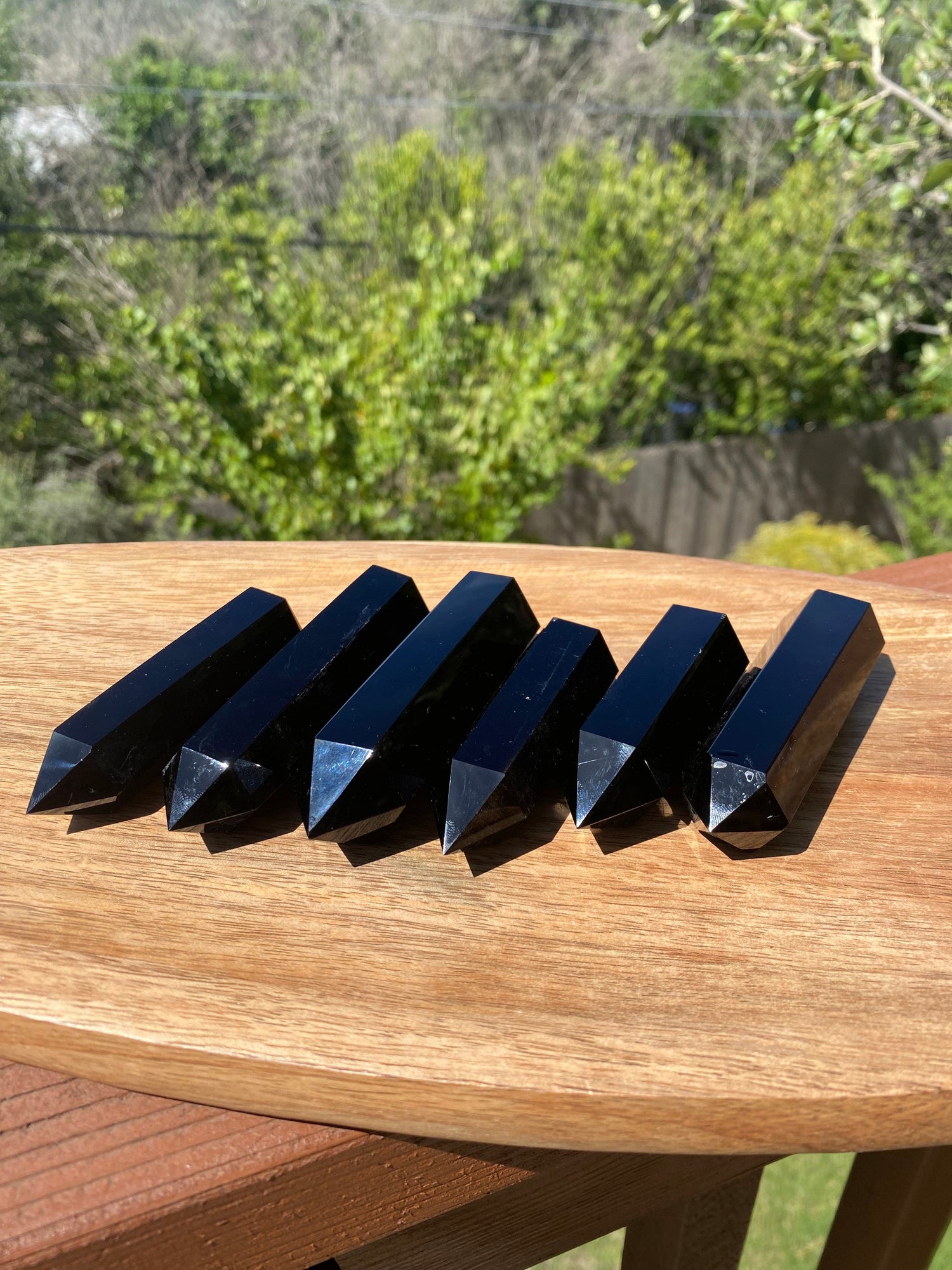 A group of Obsidian Towers reflects a powerful, grounding energy, absorbing negative emotions while promoting clarity and truth