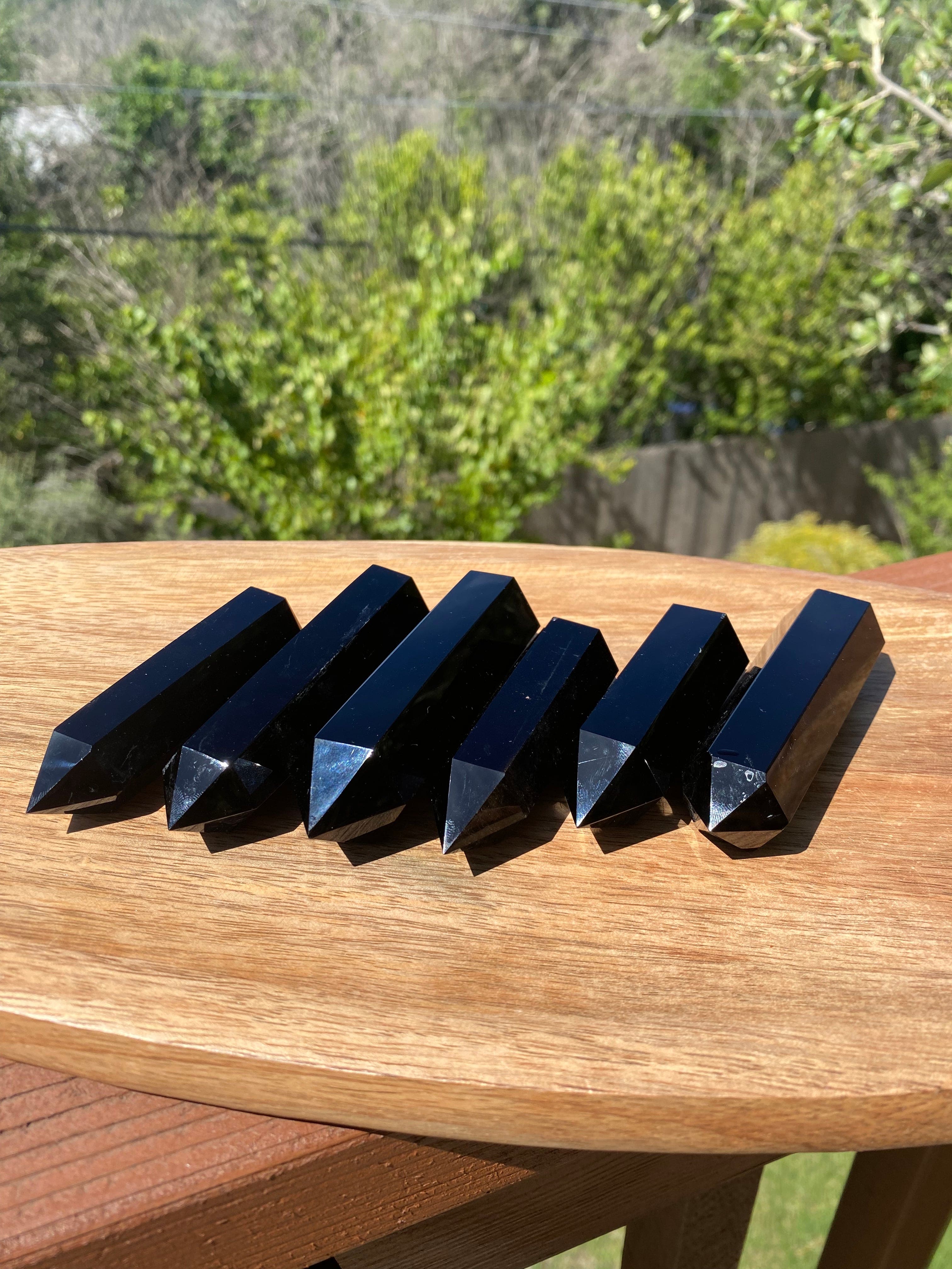 A group of Obsidian Towers reflects a powerful, grounding energy, absorbing negative emotions while promoting clarity and truth