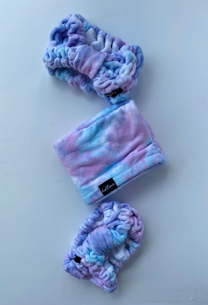 Soft and plush purple tie-dye Stella Spa Headband, ideal for a spa-like experience, providing comfort during your skincare rituals