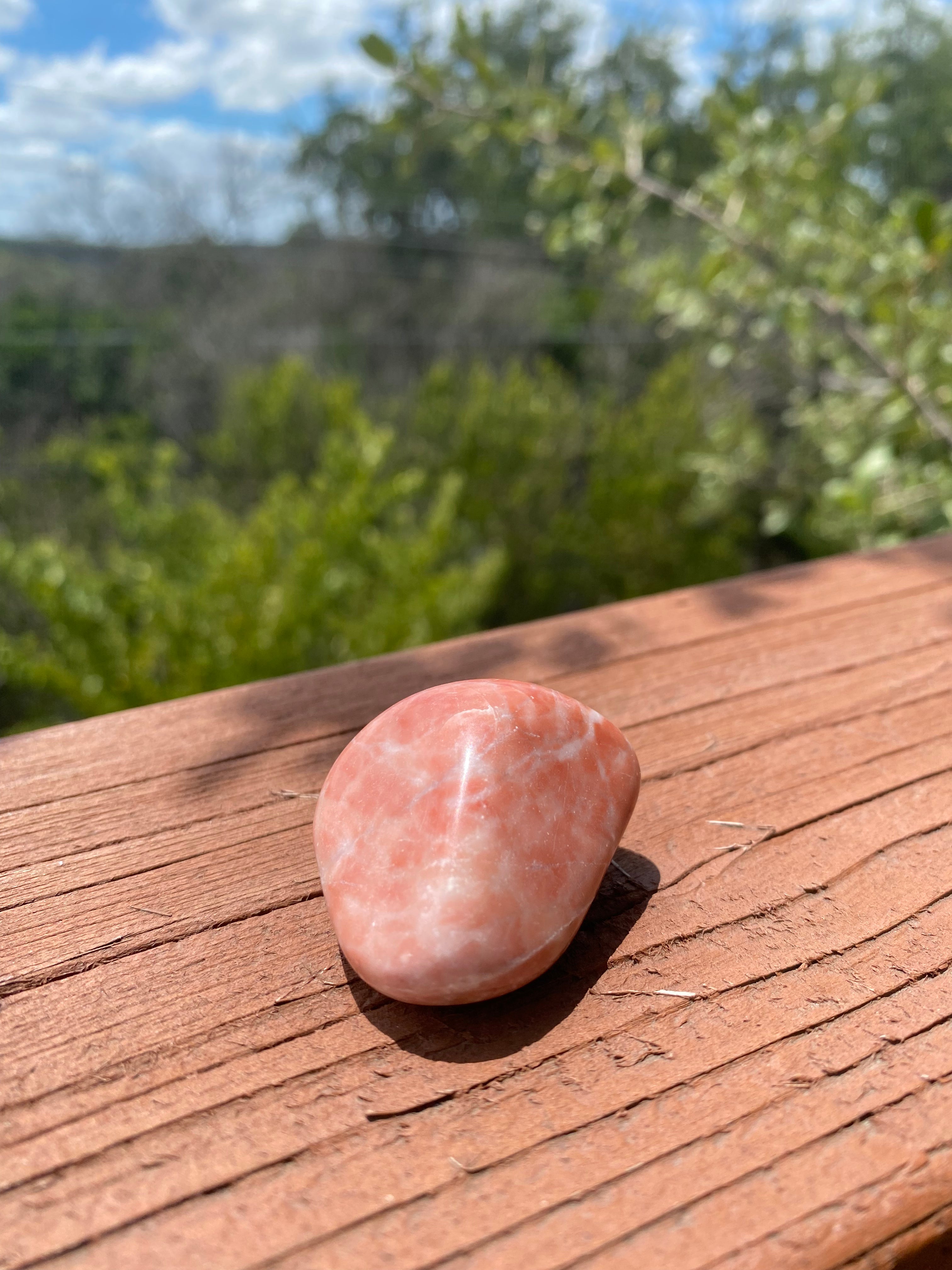 Red Aventurine Tumble shines brilliantly in sunlight, enhancing energy flow, optimism, and alignment of masculine and feminine energies