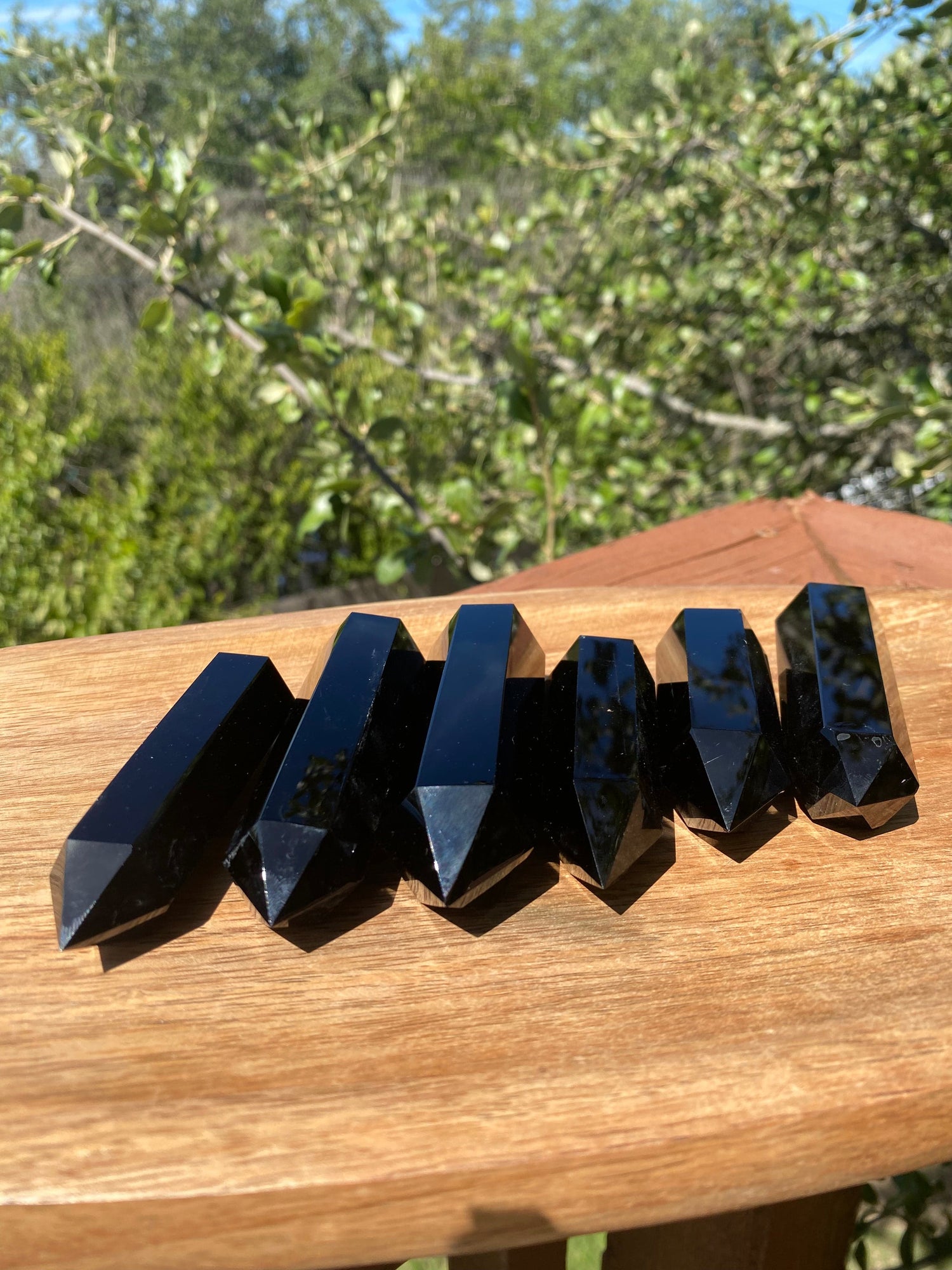 Grouped Obsidian Towers, perfectly polished, create a protective barrier that absorbs negativity and promotes emotional clarity and grounding
