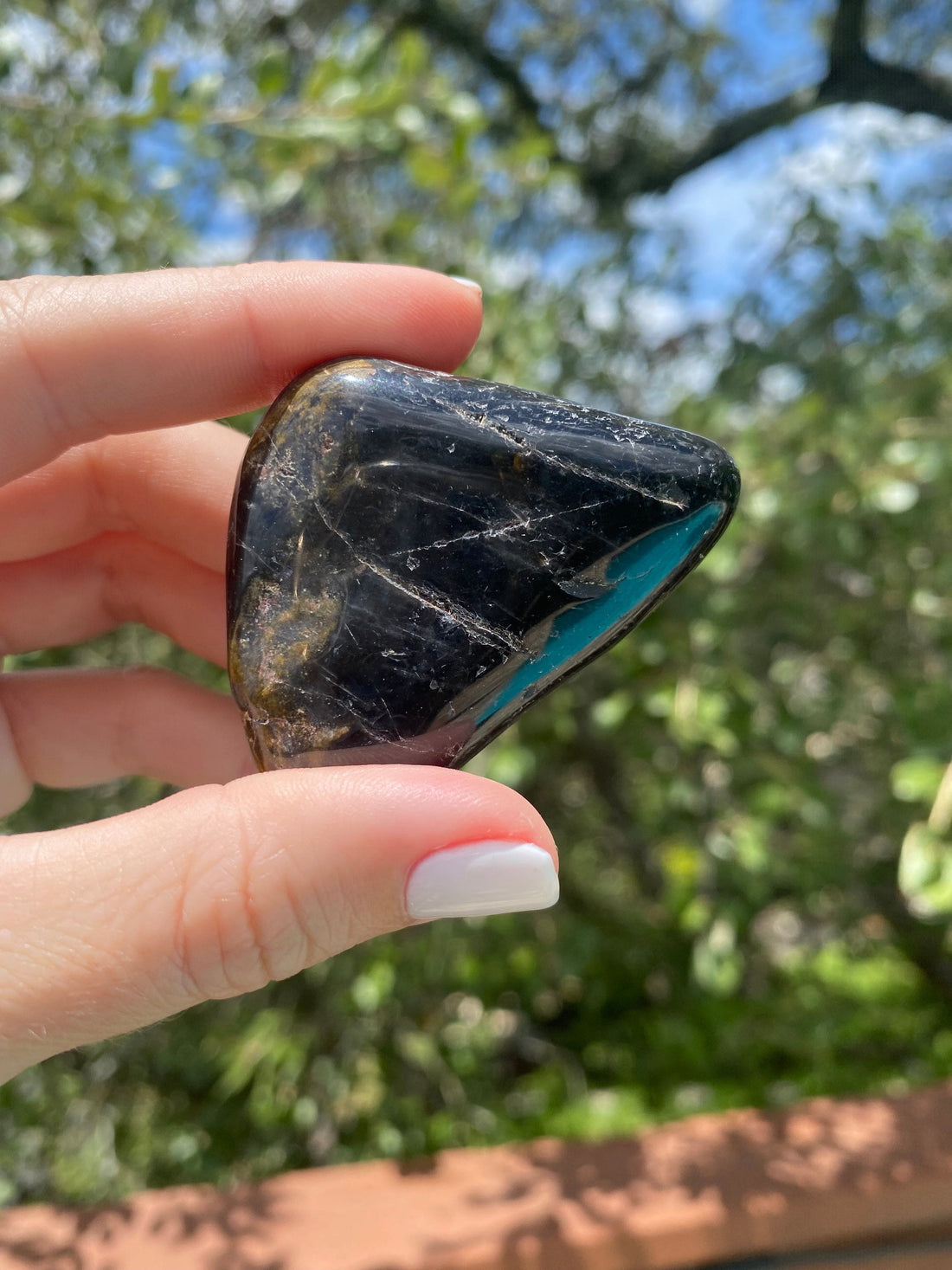 Black Tourmaline tumble stone, associated with the Root Chakra, used for grounding and blocking negative energy