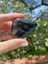 Black Tourmaline tumble stone, associated with the Root Chakra, used for grounding and blocking negative energy