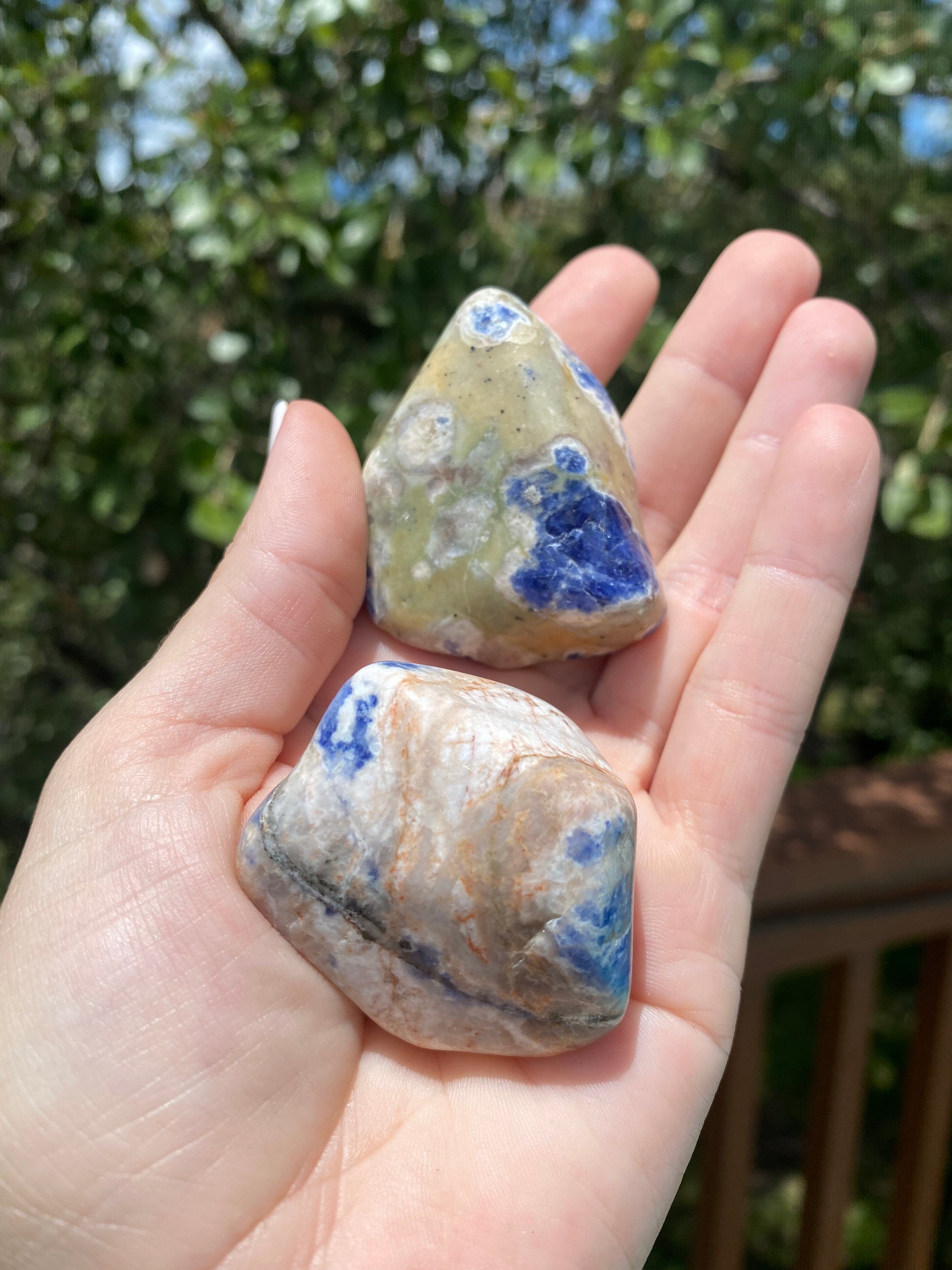 stunning Sodalite Tumble shines in hand, with intricate blue and white patterns promoting emotional balance and self-trust